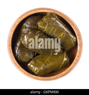Dolma, stuffed vine leaves in a bowl on white background. Sarma in Turkish or Dolmades in Greek cuisine. Stock Photo