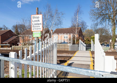 Unmanned railway crossing with fencing and barrier for pedestrians, Nottinghamshire, England, UK Stock Photo
