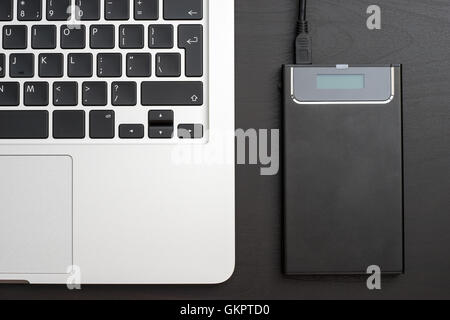 External hard disk over laptop keyboard Stock Photo