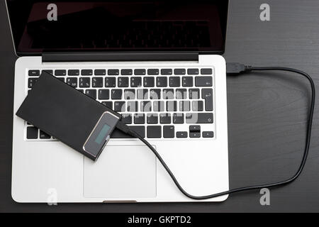 External hard disk over laptop keyboard Stock Photo