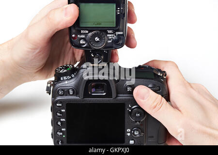 Photographer to set the external flash on a digital SLR camera Stock Photo