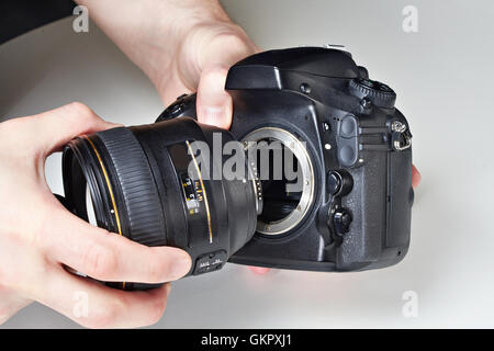 Photographer with big lens and digital SLR camera close-up Stock Photo