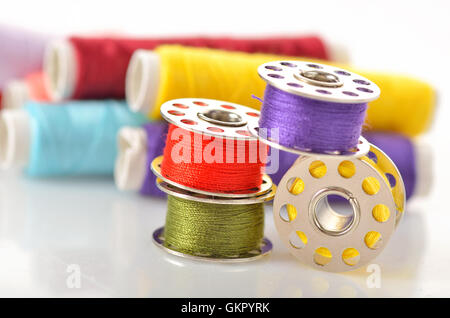 Colored bobbins for machine sewing and threads Stock Photo