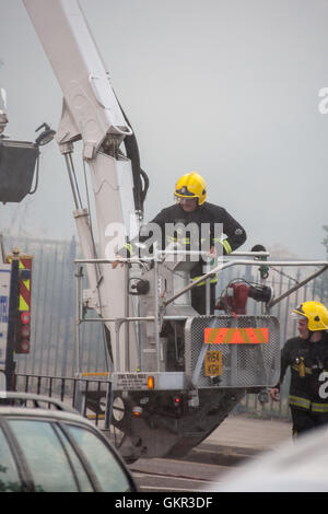 London firefighters operating a height platform at the scene of a fire in London Stock Photo