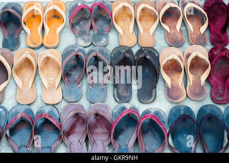 Pairs of sandals belonging to monks, outside Shwe Kyin Monastery at the ...