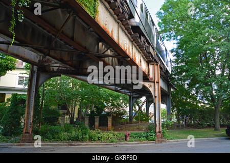 The Brown Line elevated CTA train tracks passing through yards in the residential neighborhood of Ravenswood in Chicago. Stock Photo