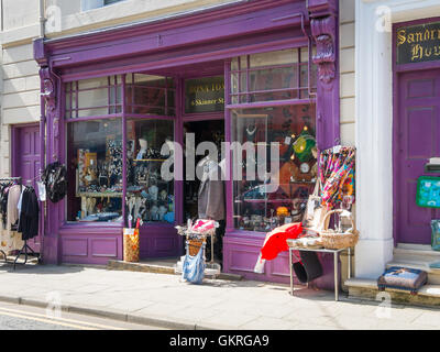 An antique and curio shop with elegant clothing on display Stock Photo