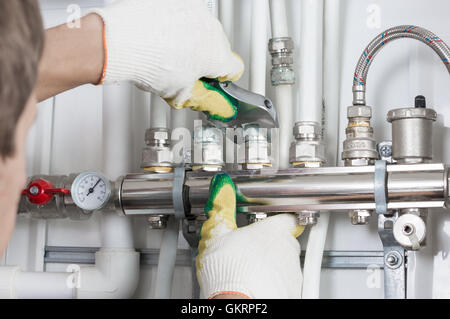 Worker fixing heating system, close up photo Stock Photo