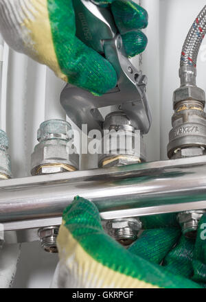 Worker fixing heating system, close up photo Stock Photo