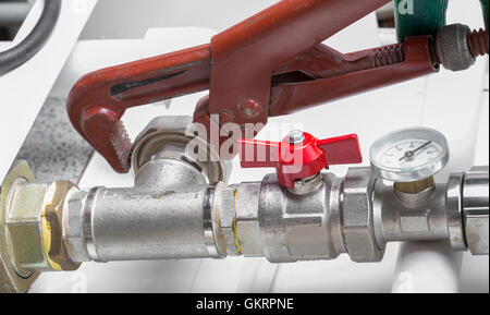 Worker fixing heating system, close up photo Stock Photo