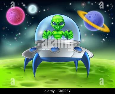 A little green man alien cartoon character piloting a flying saucer spaceship on a planet Stock Photo