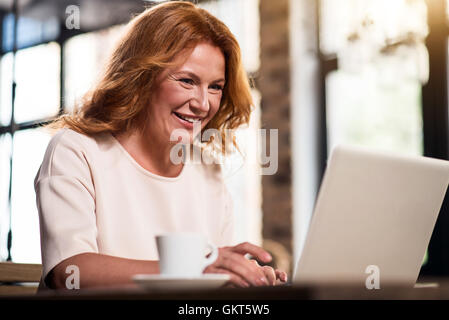 Pretty senior businesswoman using her laptop Stock Photo