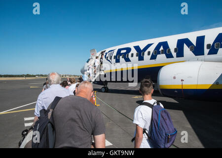 Boarding Ryanair plane at Carcassonne Airport in South of France. With blue skies for flight to Stansted,London Stock Photo