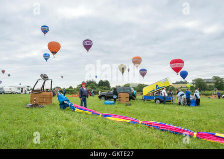 Hot air balloons being packed away as others arrive to land at the 38th annual Bristol International Balloon Fiesta Stock Photo