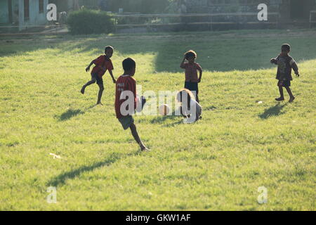 Local children playing soccer in the late afternoon at playing ground in Bajawa Flores Indonesia Stock Photo