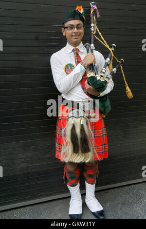 A high school student & bag pipe player in an ornate costume at the 2016  India Day Parade in New York City. Stock Photo