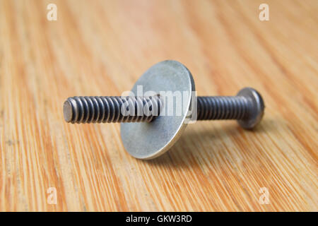 Close up of steel bolt with washer screwed on half way along, macro Stock Photo