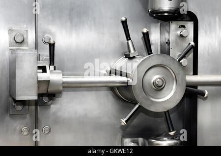 License available at MaximImages.com - Shiny stainless steel bank vault safe door lock. Banking, security, investment concept. Stock Photo