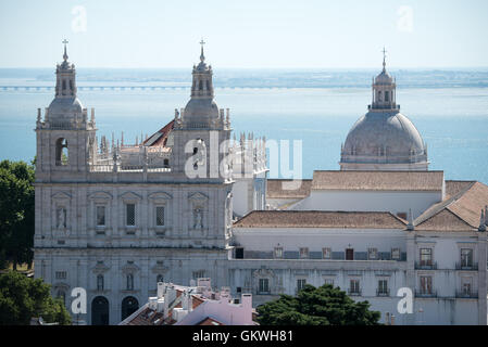 A view of Monastery of São Vicente de Fora from the ramparts of Castelo de Sao Jorge. Sitting high on a hill overlooking the center of Lisbon, São Jorge Castle (or Castelo de São Jorge or Saint George Castle) is a Moorish castle. Fortifications have existed on the site for thousands of years, and the current distinctive walls date to the 14th century. Stock Photo