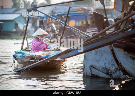 Woman cooking food on her restaurant boat Stock Photo
