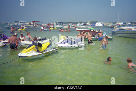 Boaters and beach goers crowd the sand bars in the Gulf of Mexico near