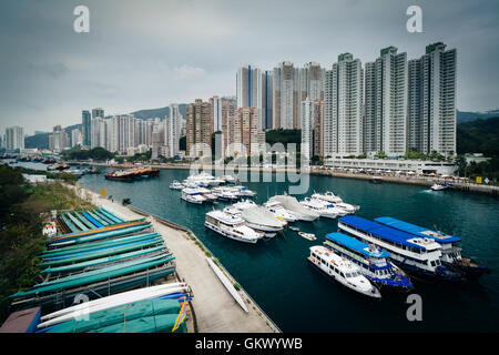View of boats and skyscrapers in Aberdeen, seen from the Ap Lei Chau Bridge, in Hong Kong. Stock Photo