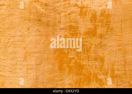 decorative antique look background texture of a terra cotta colored wall in Tuscany Stock Photo