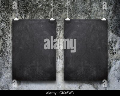 Close-up of two blank blackboard frame hanged by pegs against dirty wall background Stock Photo