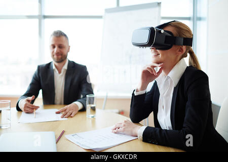 Businesswoman in vr headset looking at presentation of virtual project Stock Photo