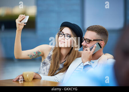 Contemporary couple using modern gadgets Stock Photo