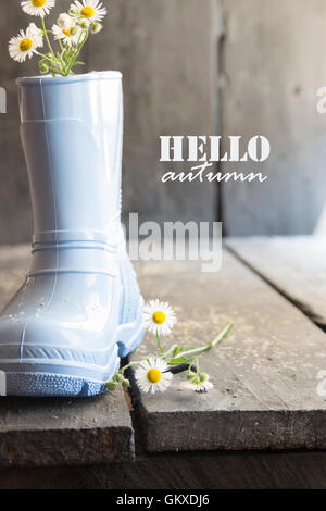 hello autumn, beautiful flowers and boots on a vintage table, Stock Photo