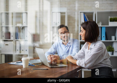 Business meeting of two young colleagues in office Stock Photo