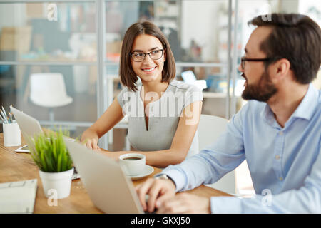Co-workers sharing ideas at meeting Stock Photo
