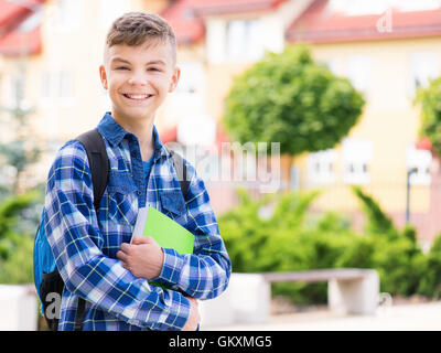 happy student boy with school bag and books Stock Photo - Alamy