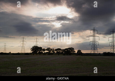 Storm clouds over pylons  in Blaxhall village Suffolk England Stock Photo