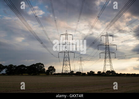 Storm clouds over pylons in Blaxhall village Suffolk England Stock Photo