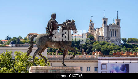 Lyon 2e arr. Statue of King Louis XIV and Fourviere basilica in background. Place Bellecour. Unesco World Heritage.Rhone Department.Rhone Alpes. France Stock Photo