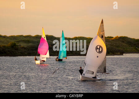 Southport, Merseyside. 24th August, 2016. UK Weather: West Lancashire Yacht Club  evening regatta at sunset with sailors enjoying the light breeze after the hottest day of the year in the north-west resort. The late evening sun turns the Marine Lake into a Golden Pond as the sailors complete the circuit in difficult weather conditions. Credit:  MediaWorldImages/Alamy Live News Stock Photo