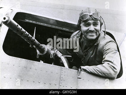 Clark Gable, a former Hollywood motion picture star now serving as a gunnery instructor with the Eighth U.S. Army Air Force in England, sits behind the waist gun of a Flying Fortress bomber at an American air base in England. Stock Photo