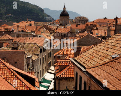 View over terracotta tiled rooftops of walled Old Town of Dubrovnik Croatia to dome of St Blaise Church Stock Photo