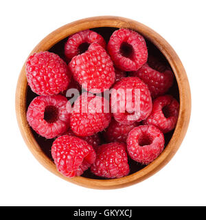 Raspberries in a wooden bowl on white background. Red ripe berries of Rubus species. Edible fruits, raw, organic and vegan food. Stock Photo
