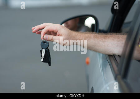 Men's hand holding a key from the car, symbolize joy purchase transport, crediting, driving Stock Photo