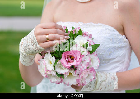 bride hands holding beautiful wedding bouquet Stock Photo