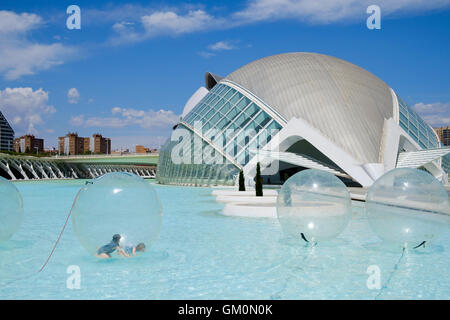 Children inside a water walking ball at the science park in front of the Hemisferic iMax building at Valencia Stock Photo