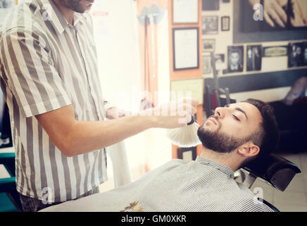 Traditional ritual of shaving the beard in a old style barber shop. Stock Photo