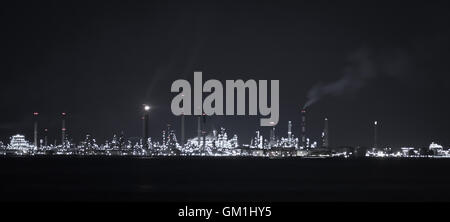 Singapore refinery runs 24/7, located on island just south of the main island. Industrial island refinery at night. Stock Photo