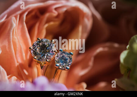 Gold engagement rings in a bouquet of rose flowers Stock Photo