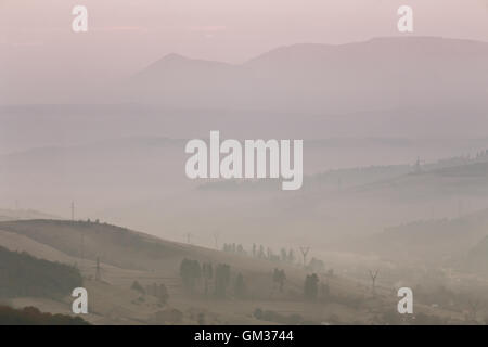 November foggy morning in Carpathian mountains. Stock Photo