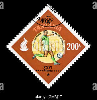 Postage stamp from Tanzania depicting a football player (soccer), issued for the 1996 Summer Olympic Games in Atlanta, Georgia. Stock Photo