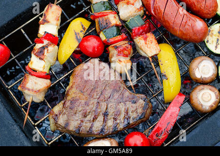 Meat and vegetables on grill. Top view Stock Photo
